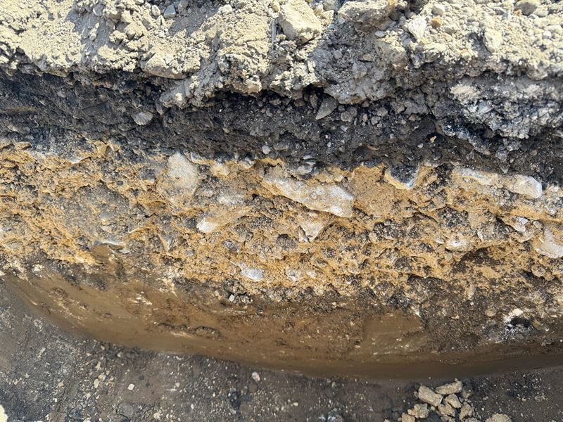 Ground conditions and standing water exposed in an excavated trench