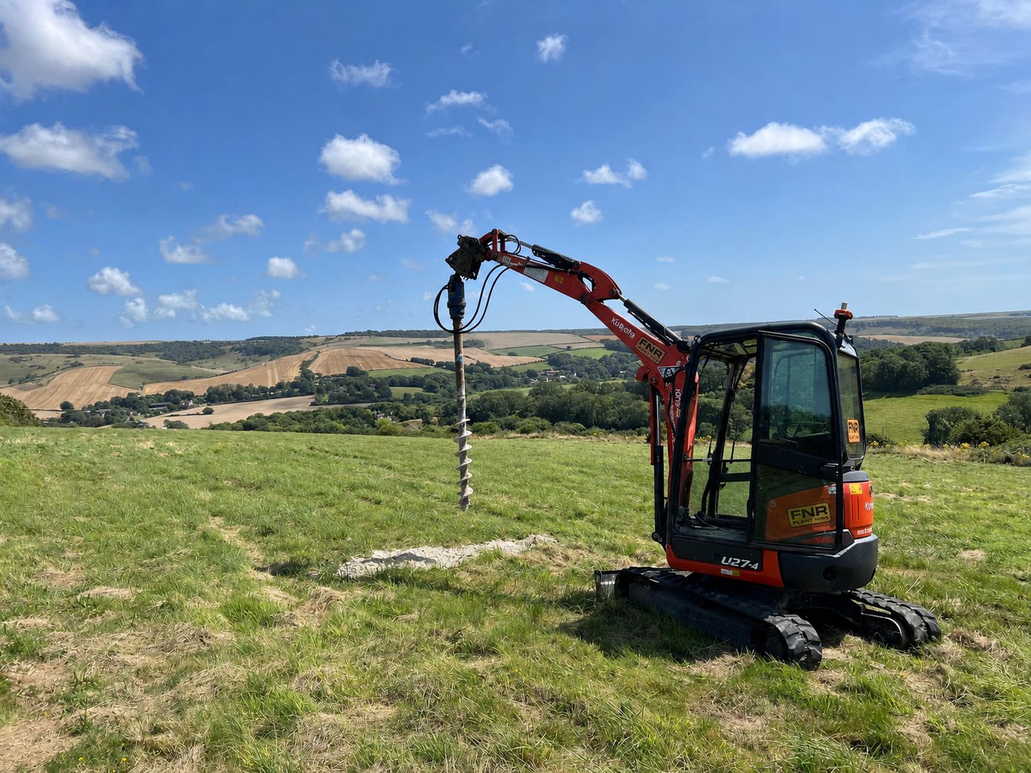 Auger rig carrying out infiltration testing on a hillside site